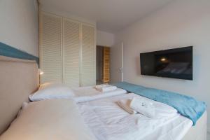 Łóżko lub łóżka w pokoju w obiekcie Mi Casa Holidays Apartamenty Olimpijska O2
