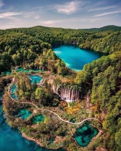 an aerial view of a lake in the forest at PLITVICE FAIRYTALE in Plitvička Jezera