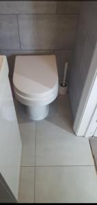 a bathroom with a white toilet in a room at London Smarty Rm in Thornton Heath +9 photos