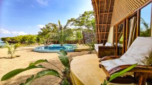 a resort with a swimming pool on the beach at Milele Villas in Potoa