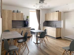 a kitchen with two tables and chairs in a room at B&B ANGELA Valdinon in Predaia