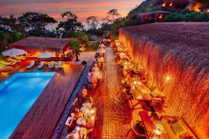a swimming pool next to a waterfall with tables at La Boheme Kabak Adults Only in Faralya +37 photos