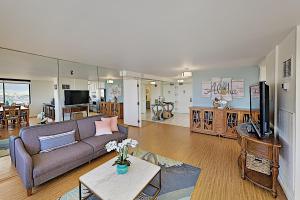 a living room with a couch and a tv at Hawaiian Monarch 203 condo in Honolulu