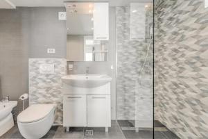 a bathroom with a sink and a toilet and a shower at Ventula in Mimice +98 photos