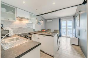 a kitchen with white appliances and a view of the ocean at Ventula in Mimice