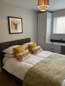 a bedroom with a bed with white sheets and yellow pillows at Stanley Street Apartment in Southport