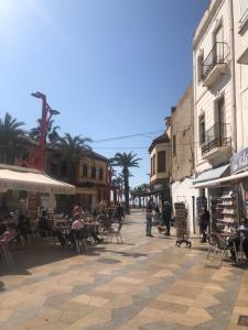 eine Gruppe von Menschen, die an Tischen in einer Straße sitzen in der Unterkunft Vinaros : Maison de Ville à 100m de la plage in Vinarós