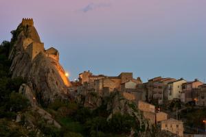 a city on top of a mountain at dusk at La Casa del Sarto in Sperlinga