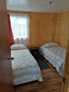 Postel nebo postele na pokoji v ubytování Cabaña María Quinchen