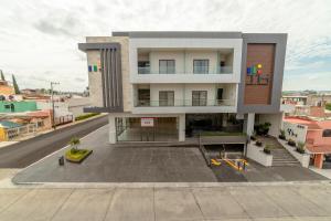 a large building with a parking lot in front of it at TH HOTEL & VIVIENDA in Tepatitlán de Morelos