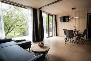 a living room with a blue couch and a table at Ferienhaus erholzeit. in Wettringen