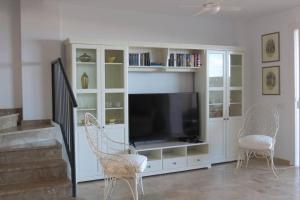 A television and/or entertainment centre at Luxury House with 3 Bedrooms, Sea Wiew and Swimming Pool in a quiet Residence