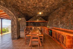 una cocina con una mesa de madera larga y sillas en Casa Dianayer, en El Paso