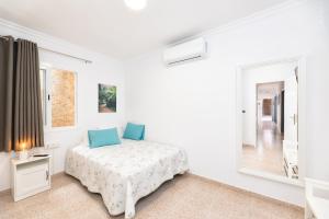 Una habitación blanca con una cama y una ventana en Casa Dianayer, en El Paso