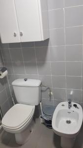 a bathroom with a white toilet and a sink at Apartamento en Campello a 250m de la playa in El Campello +16 photos