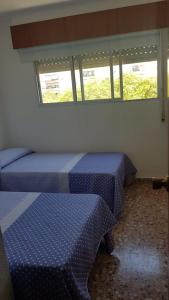 A bed or beds in a room at Apartamento en Campello a 250m de la playa