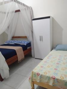 1 dormitorio con 2 camas y vestidor en Casa em Pipa 2 quartos, en Pipa