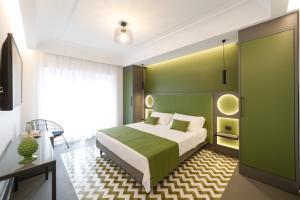 een slaapkamer met een bed en een groene muur bij Akyra suites in Sorrento