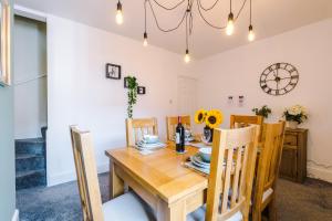a dining room with a wooden table and chairs at Spacious 2-Bed City-Centre Cottage in Chester by 53 Degrees Property - Ideal for Groups & Couples - Sleeps 6 in Chester