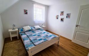 a bedroom with a bed and a window and a door at White Apartment in Keszthely