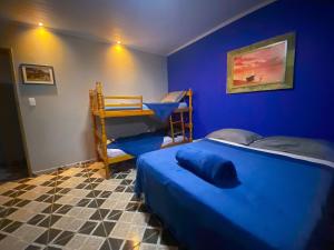 a blue bedroom with two beds and a bunk bed at Casa Luke Paraty - Praia e cachoeira in Paraty +36 photos