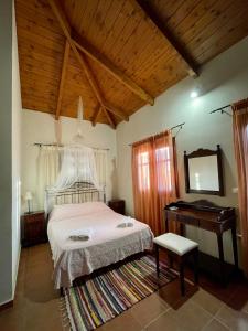 a bedroom with a bed and a table and a television at Serenita Villa in Zakynthos