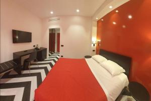 a hotel room with a bed with a red carpet at The White Lodge in Sorrento