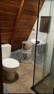 a bathroom with a toilet and a sink at Chalès em Ilhabela Litoral Norte in Ilhabela