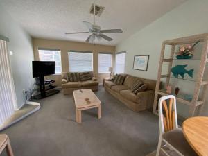 a living room with a couch and a table at K&K Vacation Homes With Private Pool in Kissimmee