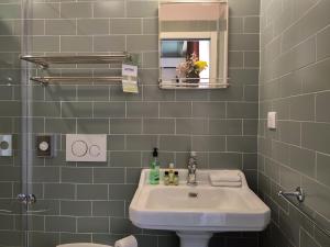 a bathroom with a sink and a mirror at Aparthotel AMMI Vieux Nice in Nice