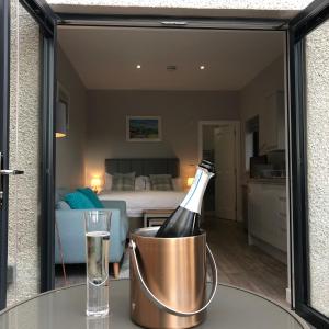 uma garrafa de champanhe num balde numa mesa num quarto em Fyrish View em Dingwall