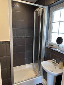 a bathroom with a shower and a sink at Harbourside in Garlieston