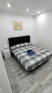 a bedroom with a large bed with a checkered blanket at Mareverde in Adeje