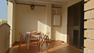 a dining room with a table and chairs at Casa Vacanza Libone in Nova Siri Marina