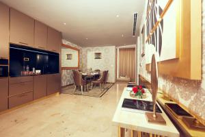 a kitchen and dining room with a table in it at Number One Oxford Street Hotel & Suites in Accra