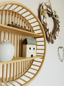 a round wooden shelf with a house on it at Seaside Sundae Suite in Lytham St Annes