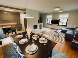 a living room with a dining table and a couch at Karkle SummerHOUSE, sea view villa in Karklė +19 photos