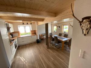 a kitchen and dining room with a table in a house at Grimm´s Landhaus in Mudau