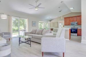 a living room with a couch and a table at Hot Tub, Breakfast, Game Room, & Close to Beaches in North Port