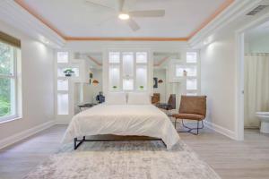a white bedroom with a bed and a ceiling fan at Hot Tub, Breakfast, Game Room, & Close to Beaches in North Port