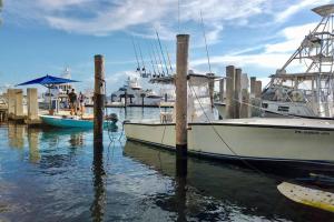 a boat docked at a dock in the water at The Beach House at Seascape Steps from the Beach, Marina and Shops! in West Palm Beach