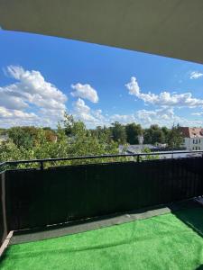 a balcony with a view of the sky at Green Penthouse in Grudziądz