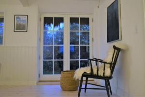 a chair in a room with a window at Tanggården Skoven in Læsø