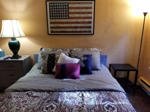 a bedroom with a bed with an american flag on the wall at Lovely One bedroom condo with indoor fireplace. in Federal Way