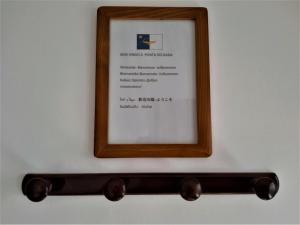 a picture frame hanging on a wall with a mirror at Adamas Bed & Breakfast in Ponta Delgada