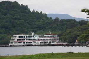 a large white cruise ship on the water at Hotel Towadaso in Towada