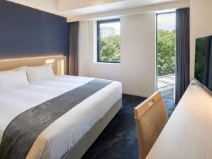 Ένα ή περισσότερα κρεβάτια σε δωμάτιο στο Hotel Keyaki Gate Tokyo Fuchu