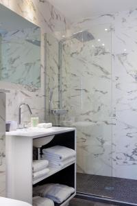 a bathroom with a sink and a shower at Hotel de Seze in Paris