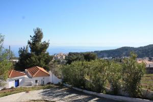 a view from the hill of a house with trees at Votsalo Apartments in Patitiri