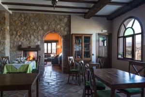 a dining room with a table and a fireplace at El Geco Verde in Castril